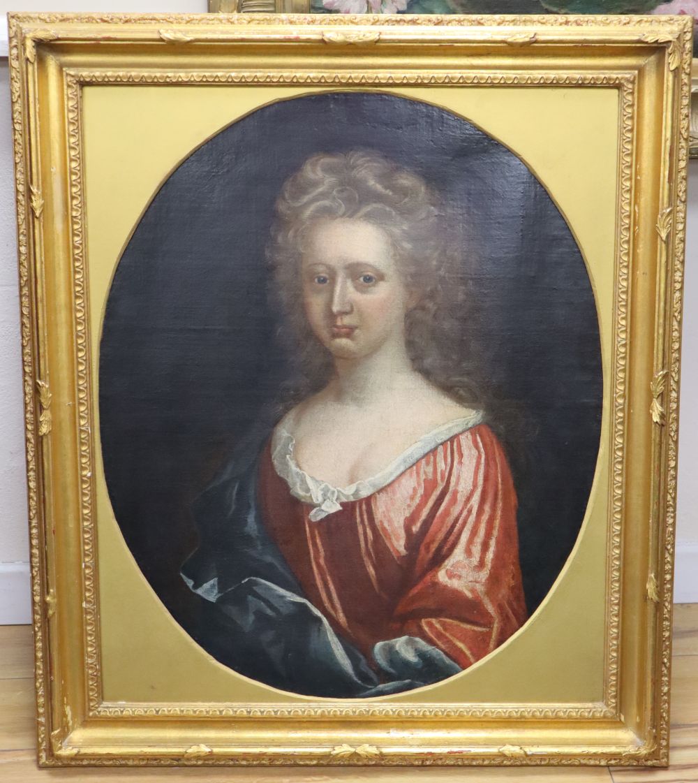 Early 18th century English School, oil on canvas, Portrait of a woman wearing a red dress, framed to the oval, 74 x 60cm